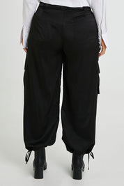 Model Laura wearing size 14 of the Date Night Cargo Pants in colour Black (Black), from the back
