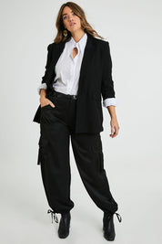 Model Laura wearing size 14 of the Date Night Cargo Pants in colour Black (Black), from the front, showing the whole outfit