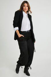Model Laura wearing size 14 of the Date Night Cargo Pants in colour Black (Black), from the front, showing the whole outfit
