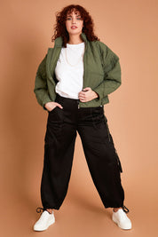 Model Maddy wearing size 16 of the Date Night Cargo Pants in colour Black (Black), from the front, showing the whole outfit