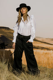 Model Tegan wearing size 10 of the Date Night Cargo Pants in colour Black (Black), from the front, showing the whole outfit