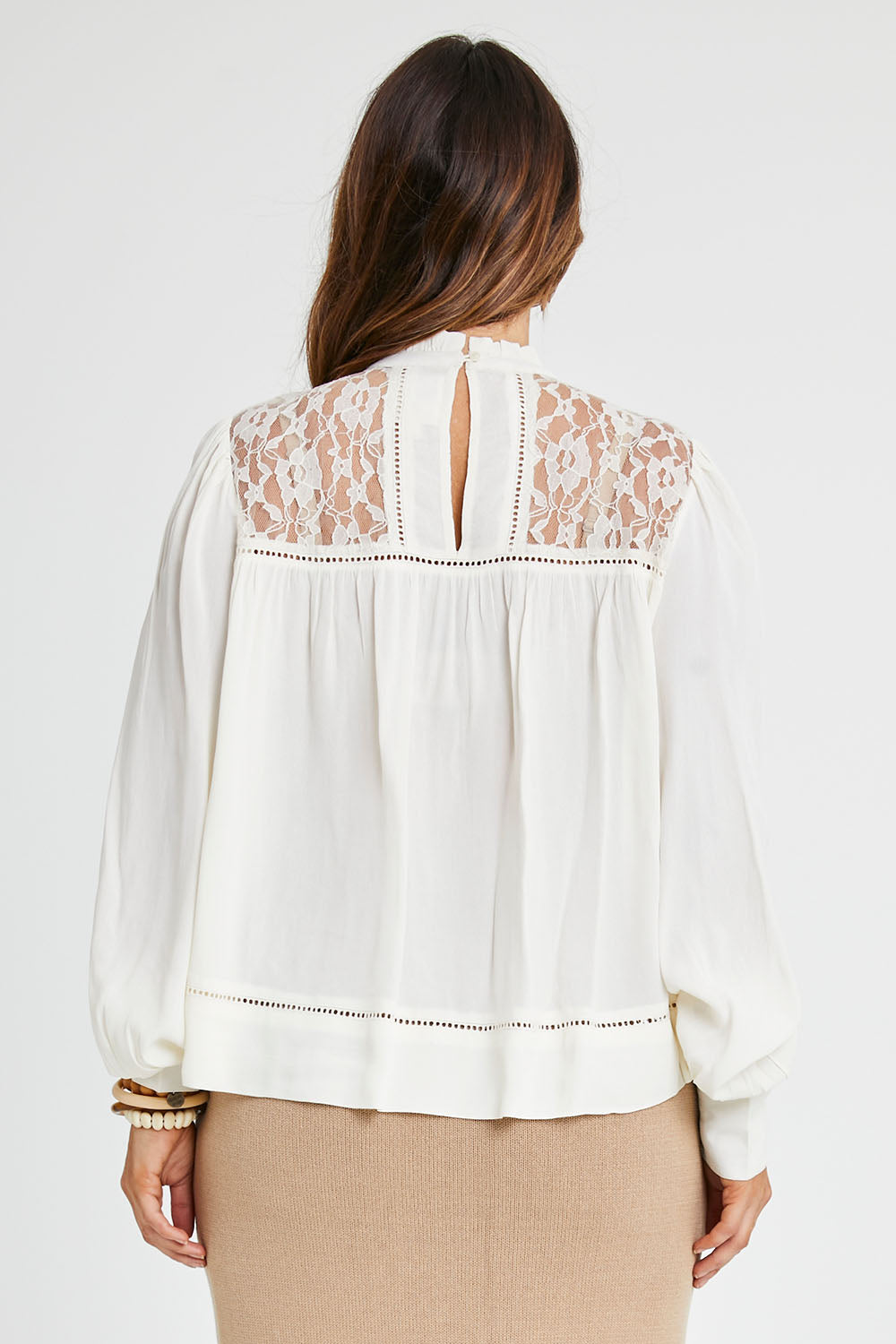 Model Laura wearing size 14 of the Im In Love Blouse in colour Buttermilk, from the back
