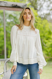 Model Tegan wearing size 14 of the Im In Love Blouse in colour Buttermilk, from the front, showing the whole outfit