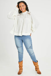 Model Tegan wearing size 14 of the Im In Love Blouse in colour Buttermilk, from the front, showing the whole outfit