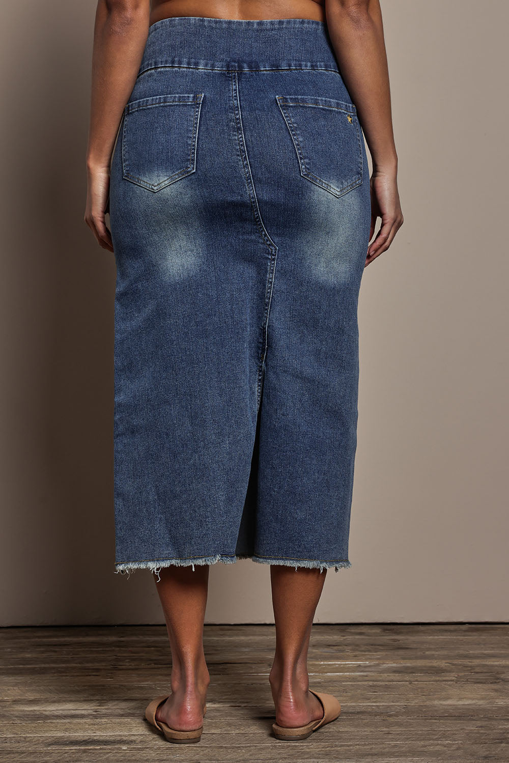 Model Tahnee wearing size 10 of the Easy As Pull On Denim Skirt in colour Darkdenim (Blue), from the back