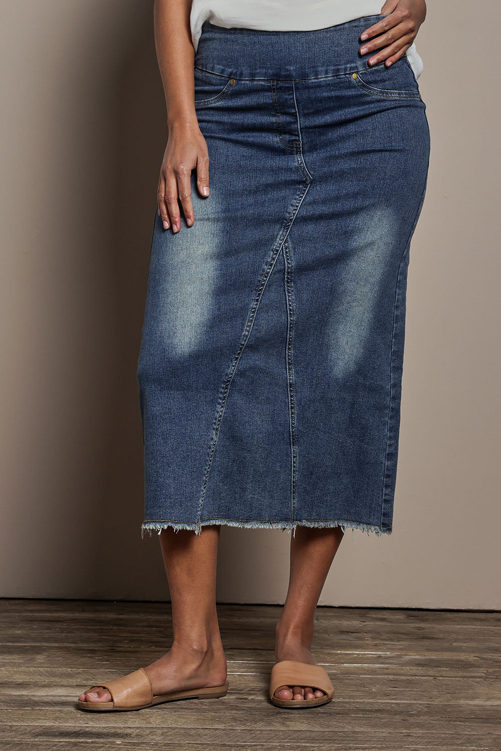 Model Tahnee wearing size 10 of the Easy As Pull On Denim Skirt in colour Darkdenim (Blue), from the front, cropped image