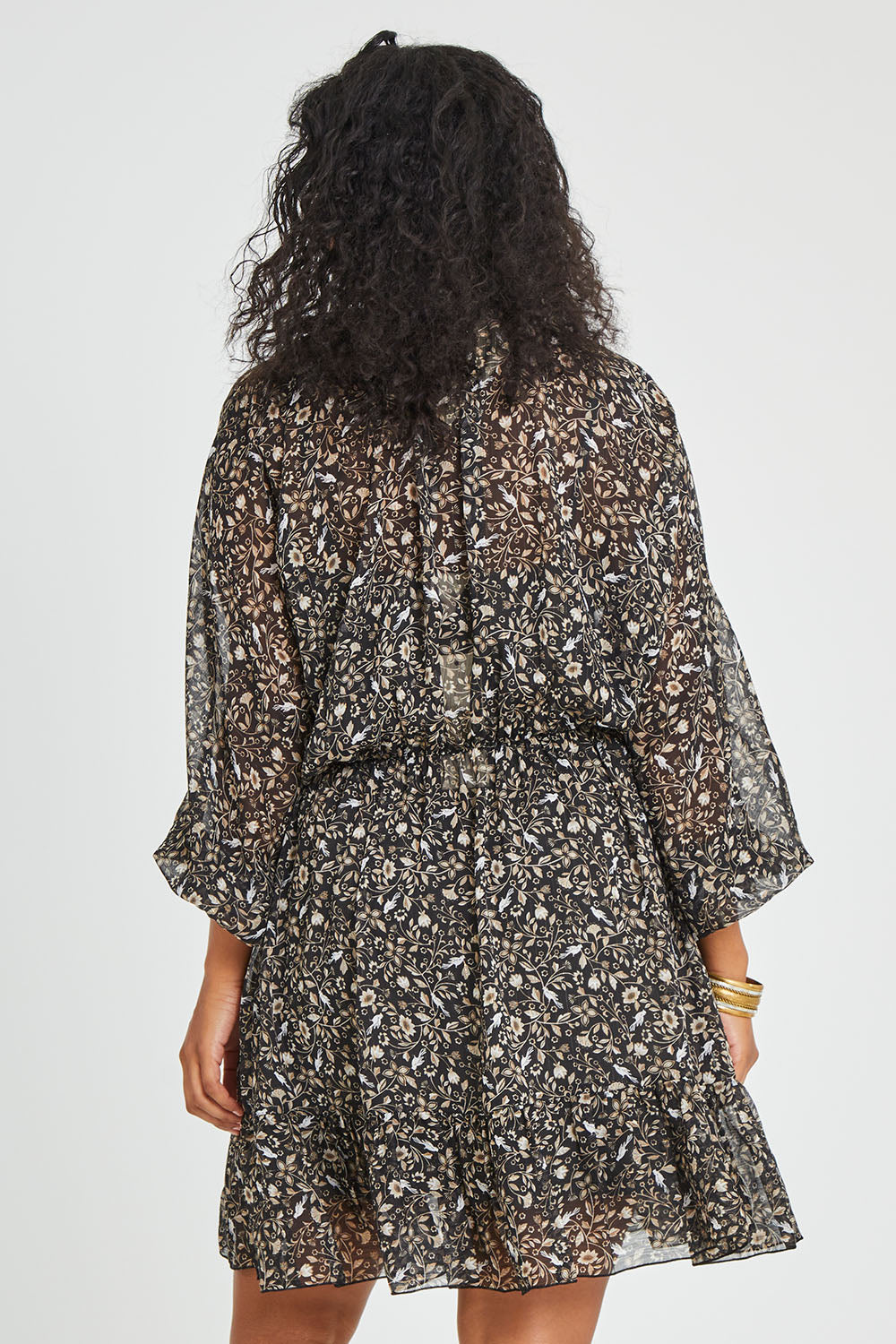 Model Noli wearing size 14 of the You Light Up The Room Dress in colour Blackbird (Black), from the back