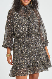 Model Noli wearing size 14 of the You Light Up The Room Dress in colour Blackbird (Black), from the front, cropped image