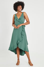 Model Aiyana wearing size 10 of the Thats A Wrap Mercerised Cotton Dress in colour Fern (Green), from the front, showing the whole outfit