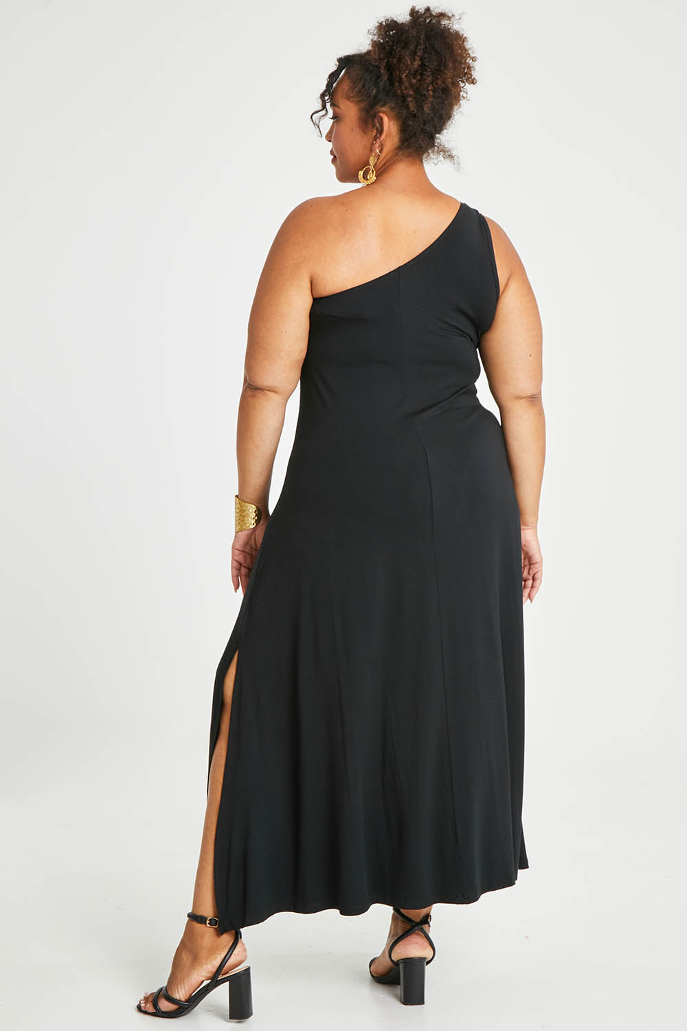 Model Alexis wearing size 16 of the Shoulder Shimmy Bamboo Maxi Dress in colour Black (Black), from the back
