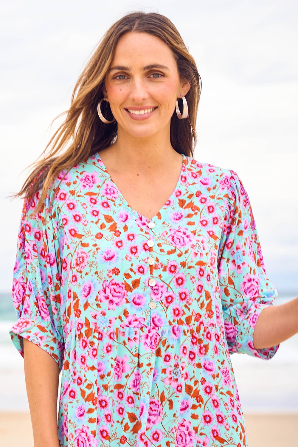 Model Tegan wearing size 10 of the Sunshine And Flowers Smock Dress in colour Aquafleur (Blue), from the front, showing the whole outfit