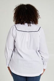 Model Alexis wearing size 16 of the Ric Rac Romance Blouse in colour White (White), from the back