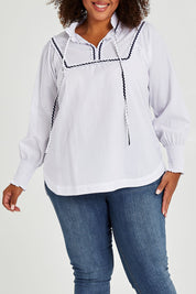 Model Alexis wearing size 16 of the Ric Rac Romance Blouse in colour White (White), from the front, cropped image