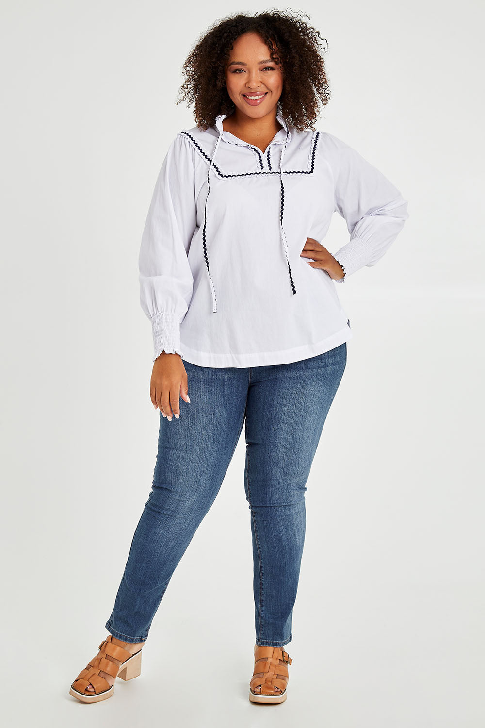 Model Alexis wearing size 16 of the Ric Rac Romance Blouse in colour White (White), from the front, showing the whole outfit