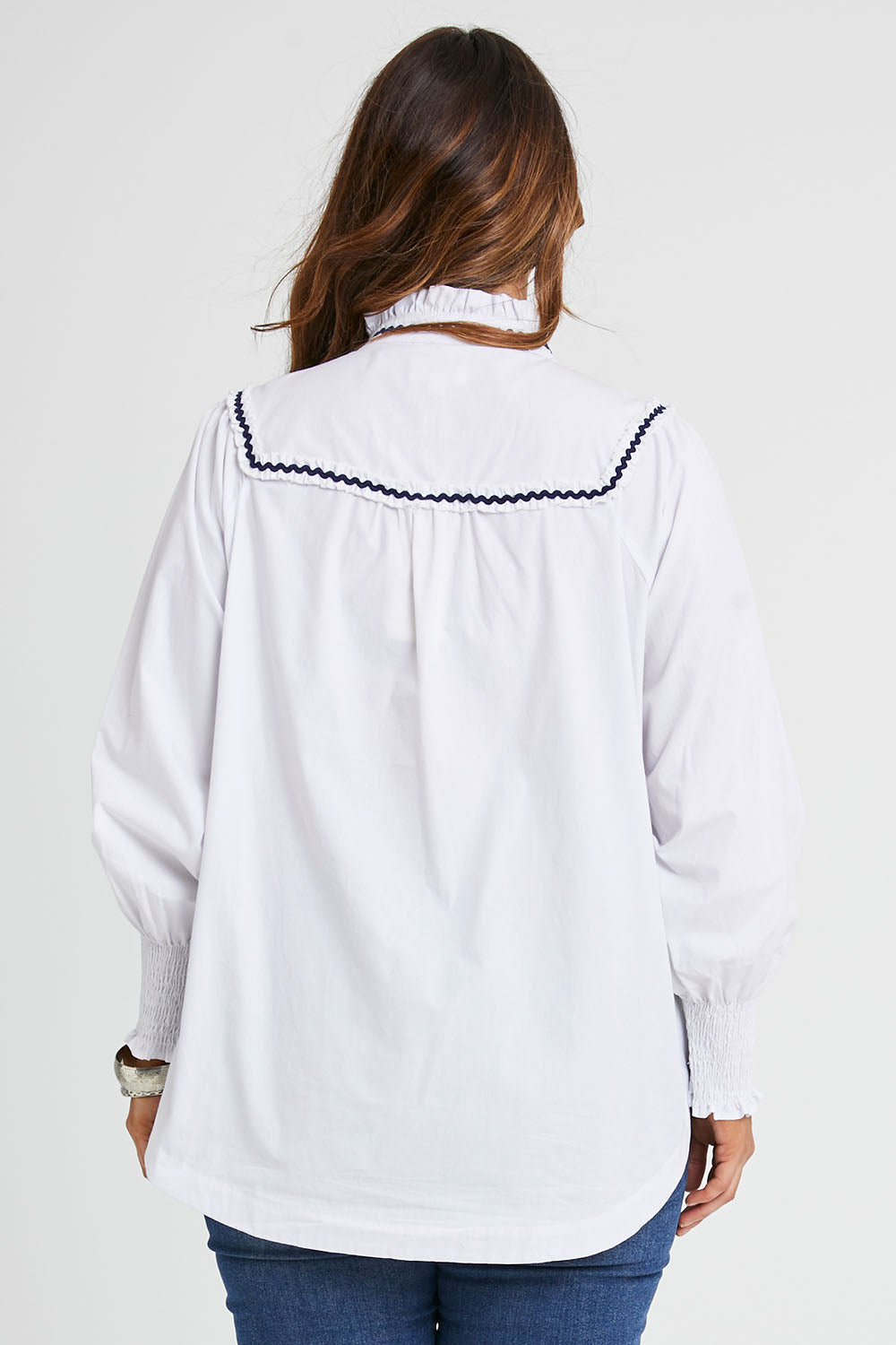Model Laura wearing size 14 of the Ric Rac Romance Blouse in colour White (White), from the back