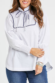 Model Laura wearing size 14 of the Ric Rac Romance Blouse in colour White (White), from the front, cropped image