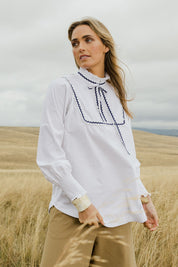 Model Tegan wearing size 10 of the Ric Rac Romance Blouse in colour White (White), from the front, showing the whole outfit