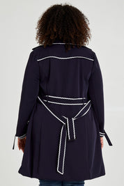 Model Alexis wearing size 16 of the Forever In Style Trench Coat in colour Navy (Blue), from the back