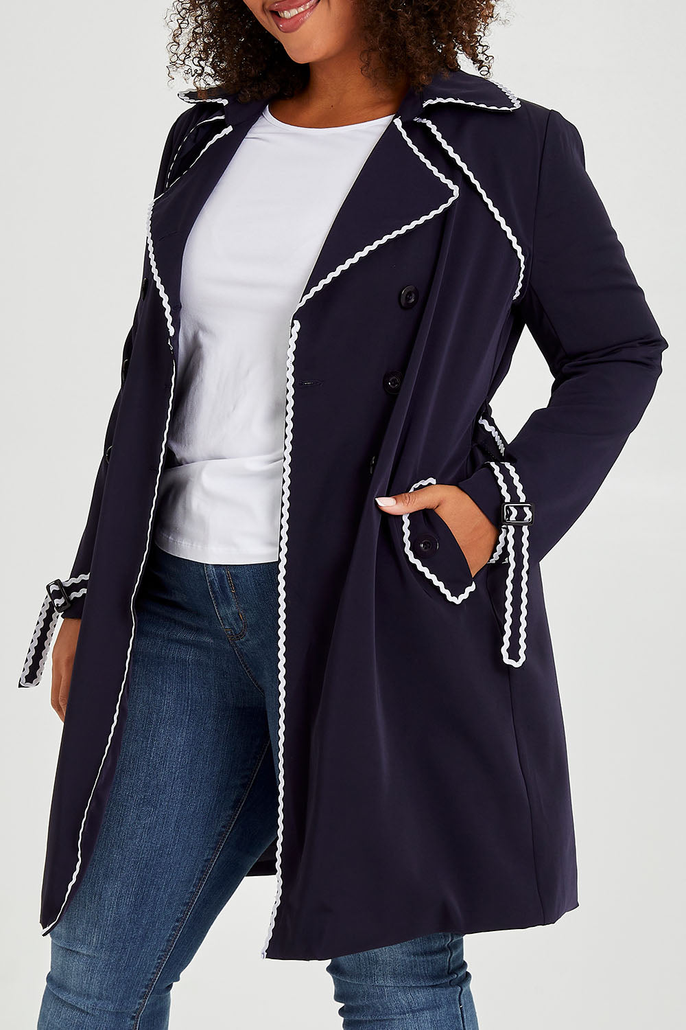Model Alexis wearing size 16 of the Forever In Style Trench Coat in colour Navy (Blue), from the front, cropped image