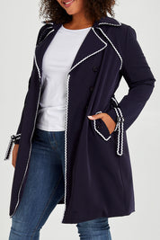 Model Alexis wearing size 16 of the Forever In Style Trench Coat in colour Navy (Blue), from the front, cropped image