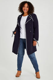 Model Alexis wearing size 16 of the Forever In Style Trench Coat in colour Navy (Blue), from the front, showing the whole outfit