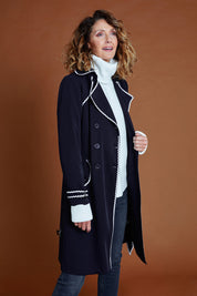Model Emma wearing size 10 of the Forever In Style Trench Coat in colour Navy (Blue), from the front, cropped image