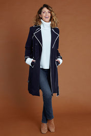 Model Emma wearing size 10 of the Forever In Style Trench Coat in colour Navy (Blue), from the front, showing the whole outfit