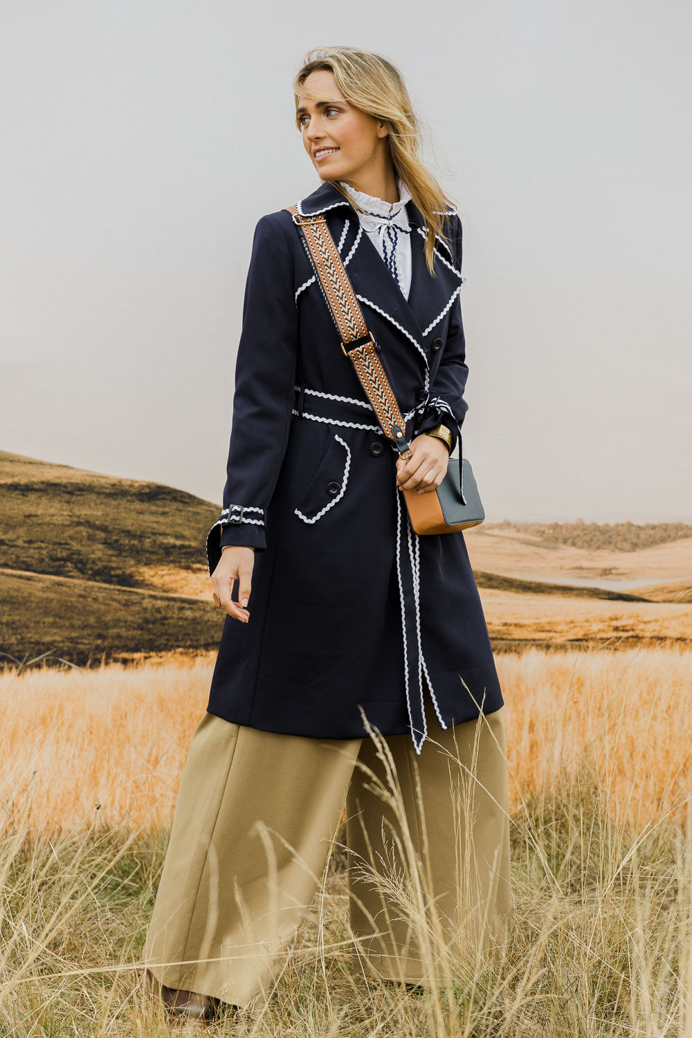 Model Tegan wearing size 10 of the Forever In Style Trench Coat in colour Navy (Blue), from the front, showing the whole outfit