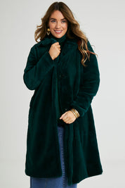 Model Laura wearing size 14 of the Adore You Faux Fur Coat in colour Lagoon (Green), from the front, cropped image