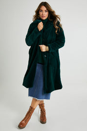 Model Laura wearing size 14 of the Adore You Faux Fur Coat in colour Lagoon (Green), from the front, showing the whole outfit