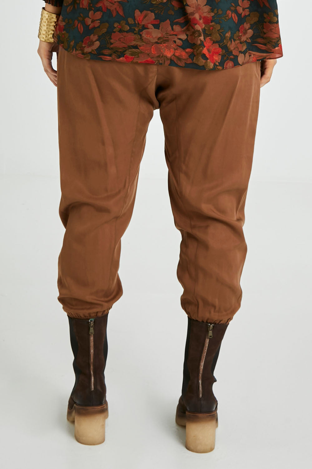 Model Laura wearing size 14 of the Brunch and Dinner Tencel Pants in colour Rust, from the back