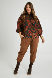 Model Laura wearing size 14 of the Brunch and Dinner Tencel Pants in colour Rust, from the front, showing the whole outfit