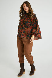 Model Laura wearing size 14 of the Brunch and Dinner Tencel Pants in colour Rust, from the front, showing the whole outfit