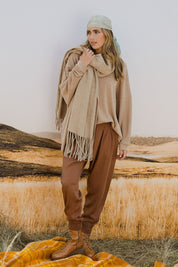Model Tegan wearing size 10 of the Brunch and Dinner Tencel Pants in colour Rust, from the front, showing the whole outfit