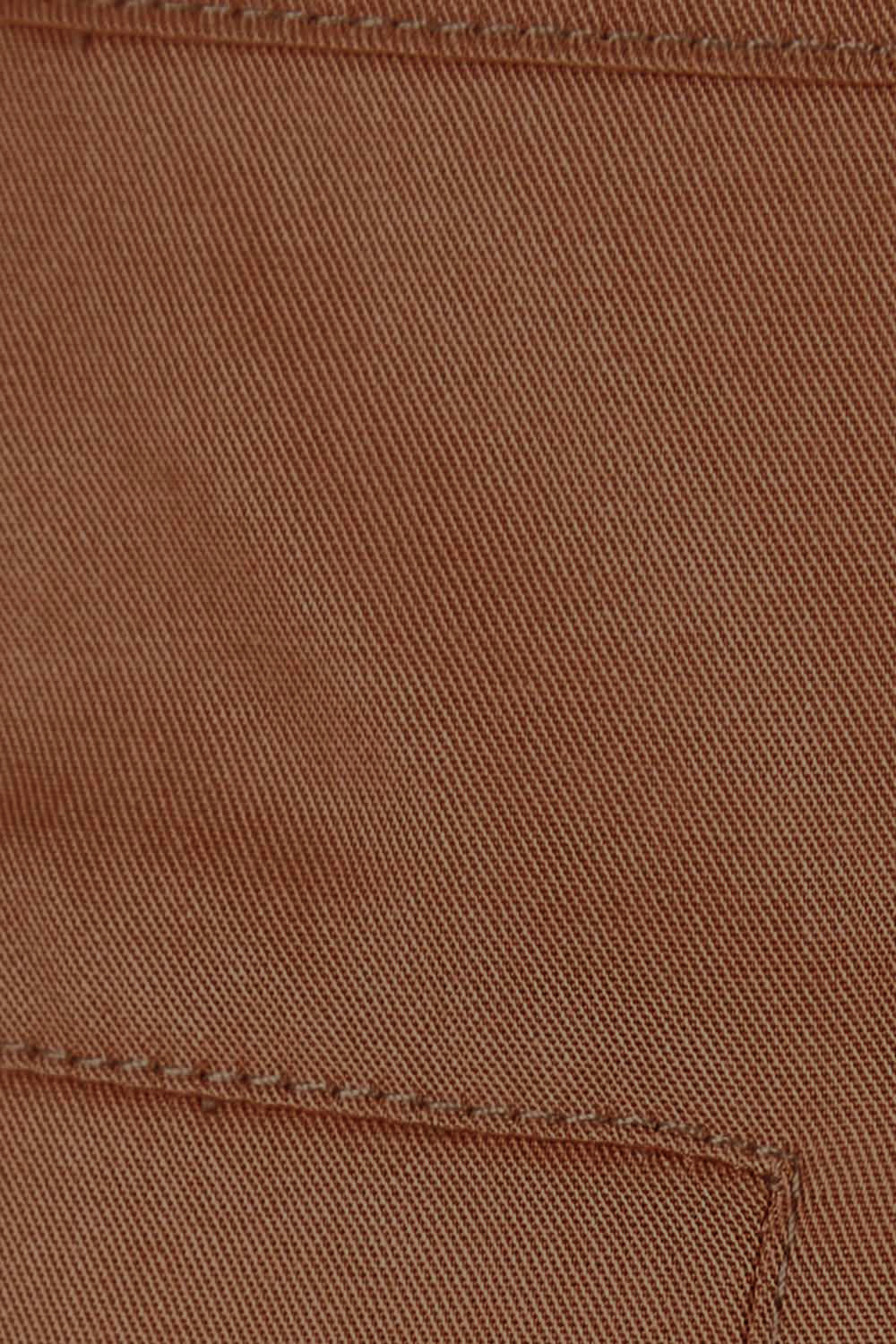 Product shot of the Brunch and Dinner Tencel Pants in colour Rust, detail