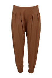 Product shot of the Brunch and Dinner Tencel Pants in colour Rust, from the front