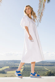 Model Tegan wearing size 10 of the Light The Way Lantern Sleeve Dress in colour White (White), from the front, showing the whole outfit