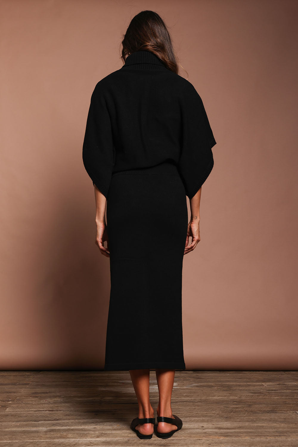 Model Amanda wearing size S of the Knit Pick Pull On Skirt in colour Black (Black), from the back