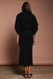 Model Amanda wearing size S of the Knit Pick Pull On Skirt in colour Black (Black), from the back