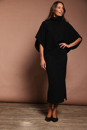 Model Amanda wearing size S of the Knit Pick Pull On Skirt in colour Black (Black), from the front, showing the whole outfit