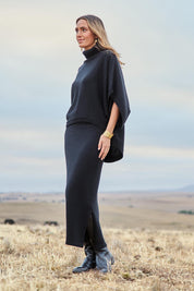 Model Tegan wearing size S of the Knit Pick Pull On Skirt in colour Black (Black), from the front, showing the whole outfit