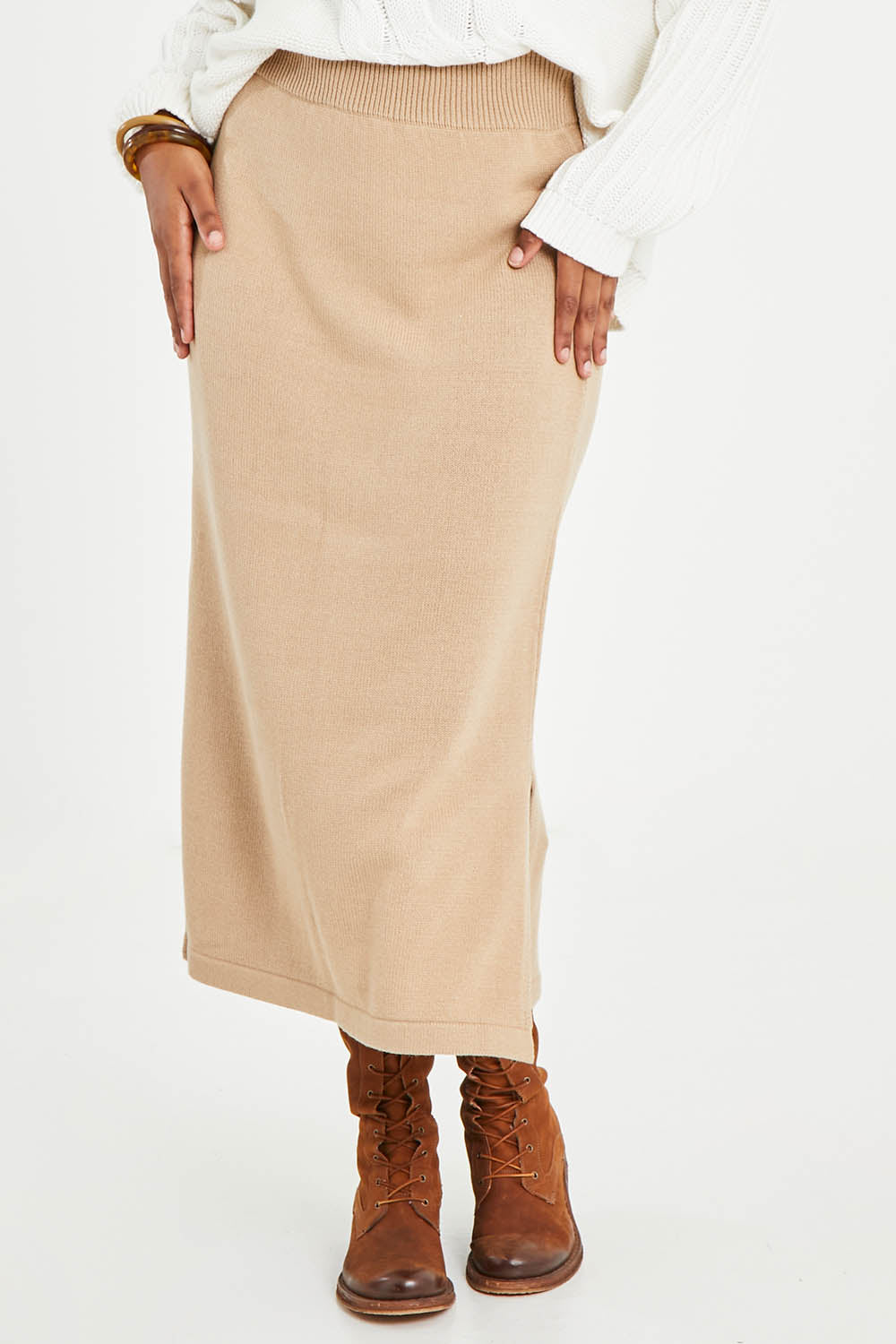Model Noli wearing size L of the Knit Pick Pull On Skirt in colour Sand, from the front, cropped image
