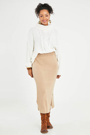 Model Noli wearing size L of the Knit Pick Pull On Skirt in colour Sand, from the front, showing the whole outfit