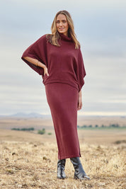 Model Tegan wearing size S of the Knit Pick Pull On Skirt in colour Wine (Purple), from the front, showing the whole outfit