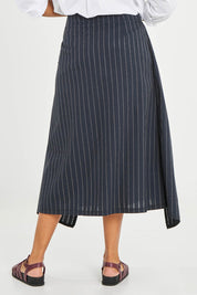 Model Noli wearing size 14 of the Sweet Delight Apron Wrap Skirt in colour Blkstripe (Black), from the back