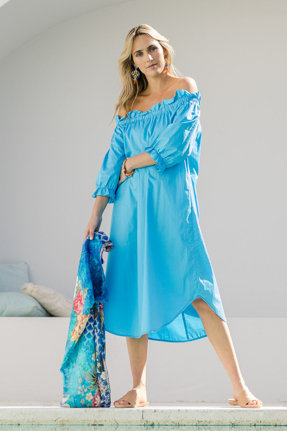 Model Tegan wearing size 10 of the Good Vibes Off Shoulder Cotton Dress in colour Bluerad (Blue), from the front, showing the whole outfit