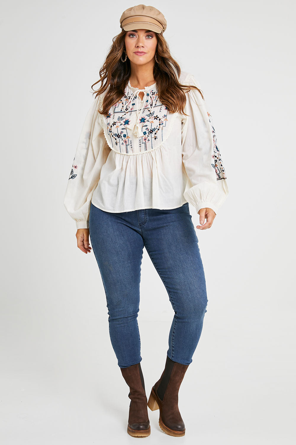 Model Laura wearing size 14 of the My Happiness Embroidered Blouse in colour Sand, from the front, showing the whole outfit