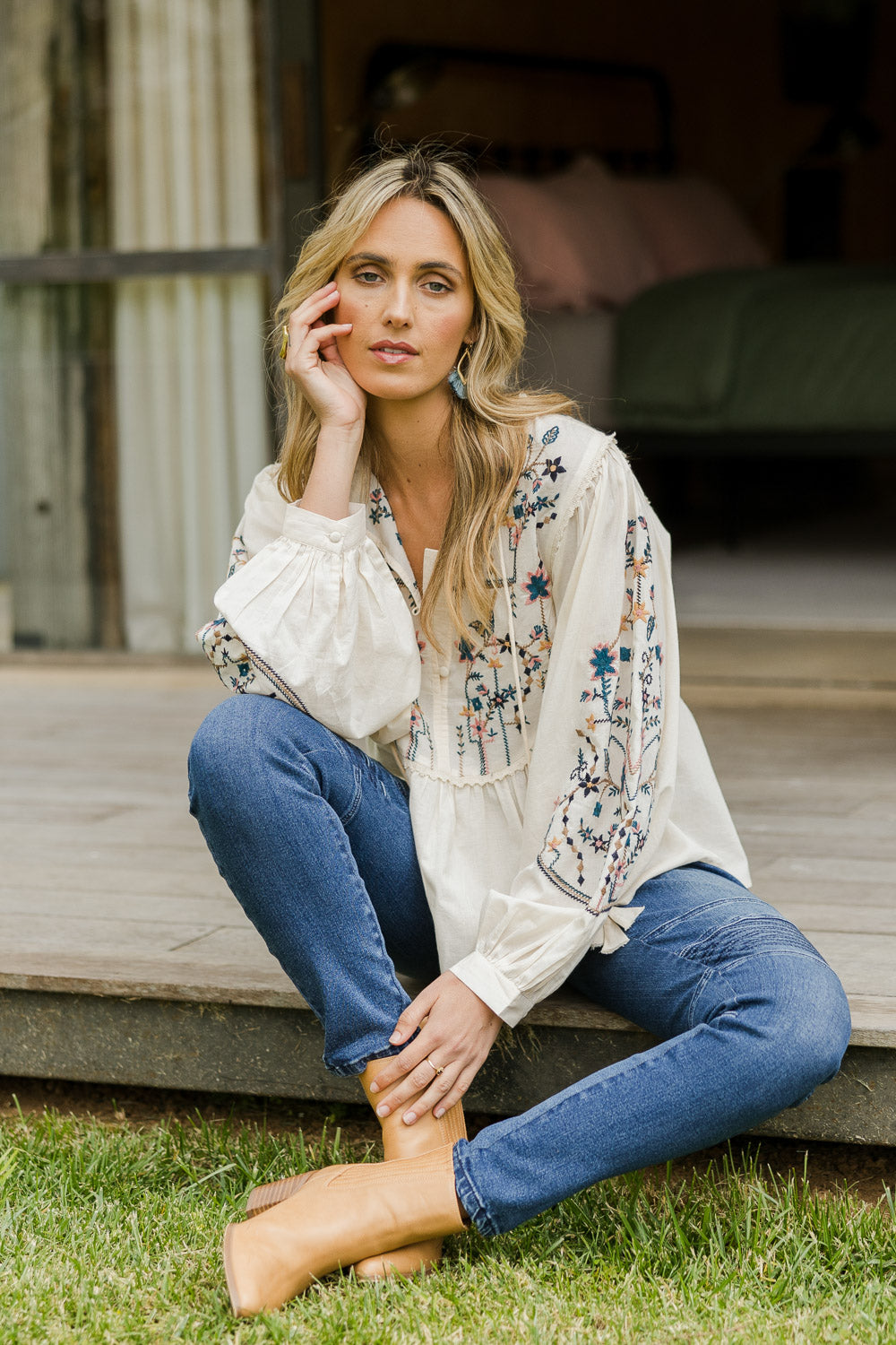 Model Tegan wearing size 10 of the My Happiness Embroidered Blouse in colour Sand, from the front, showing the whole outfit