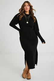 Model Laura wearing size L of the Day Or Night Balloon Sleeve Dress in colour Black (Black), from the front, showing the whole outfit