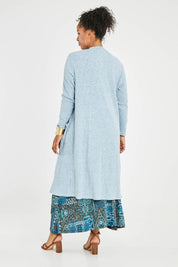 Model Noli wearing size 14 of the Sunset Watching Cardi in colour Sky (Blue), from the back